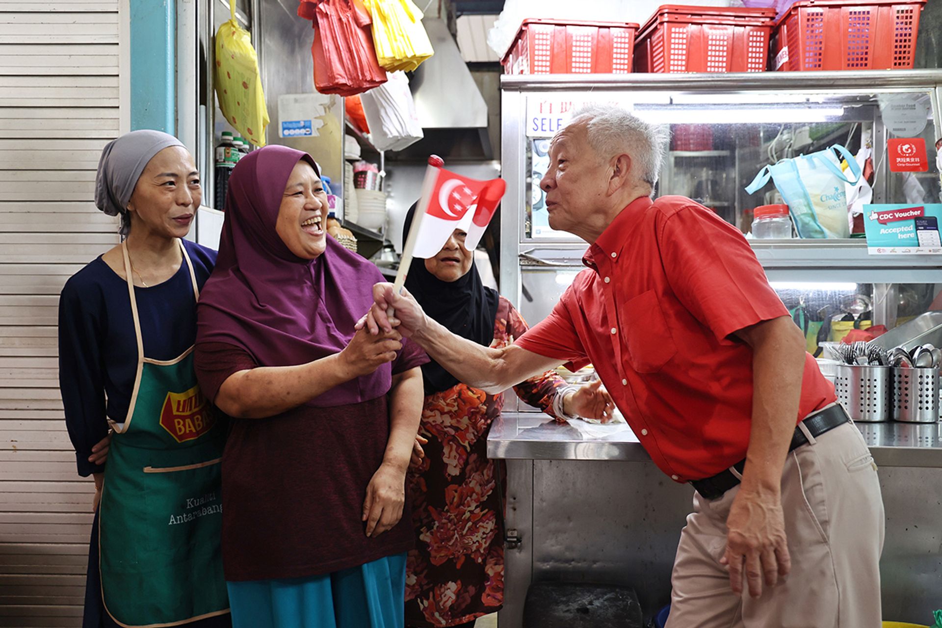 Mr Ng interacting with residents and stallholders in the market at The Marketplace@58 in New Upper Changi Road on Aug 11, 2023. ST PHOTO: HESTER TAN