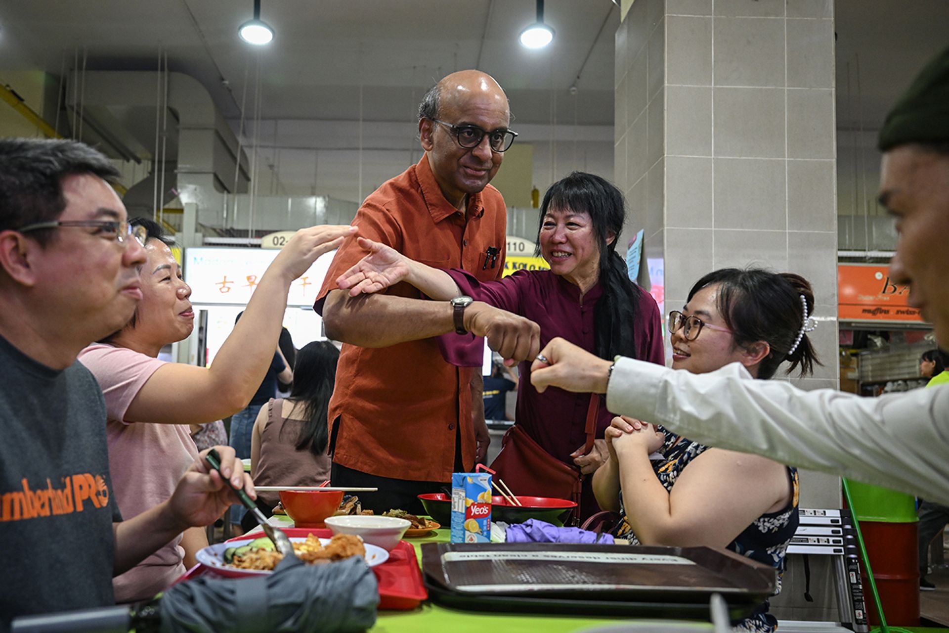 Mr Tharman and his wife greeting customers at Amoy Street Food Centre on Aug 25, 2023. ST PHOTO: SHINTARO TAY