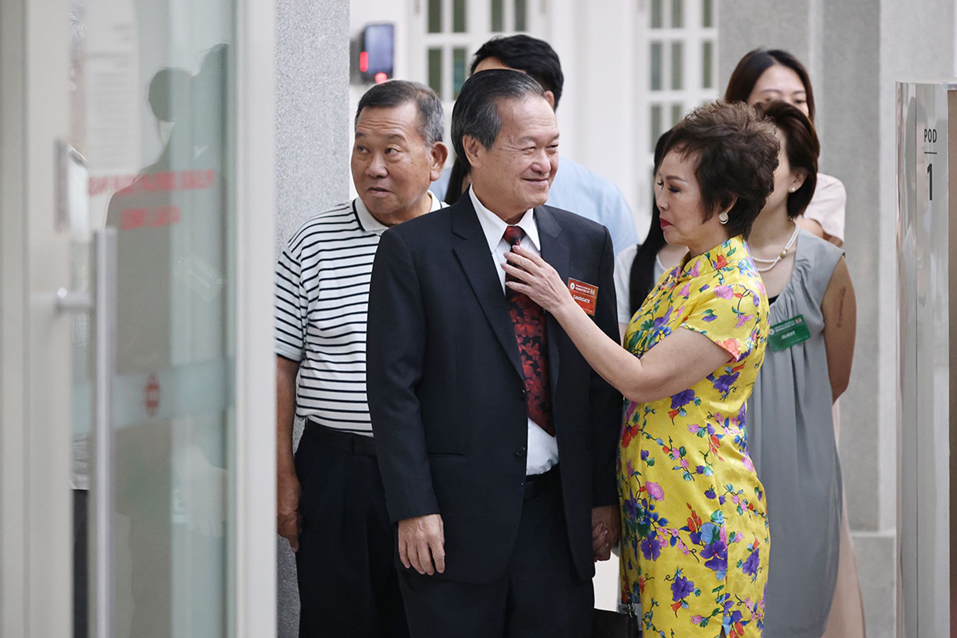 Mr Tan getting a quick touch-up from his wife Tay Siew Hong before he delivers a speech at the nomination centre on Aug 22, 2023. ST PHOTO: JASON QUAH