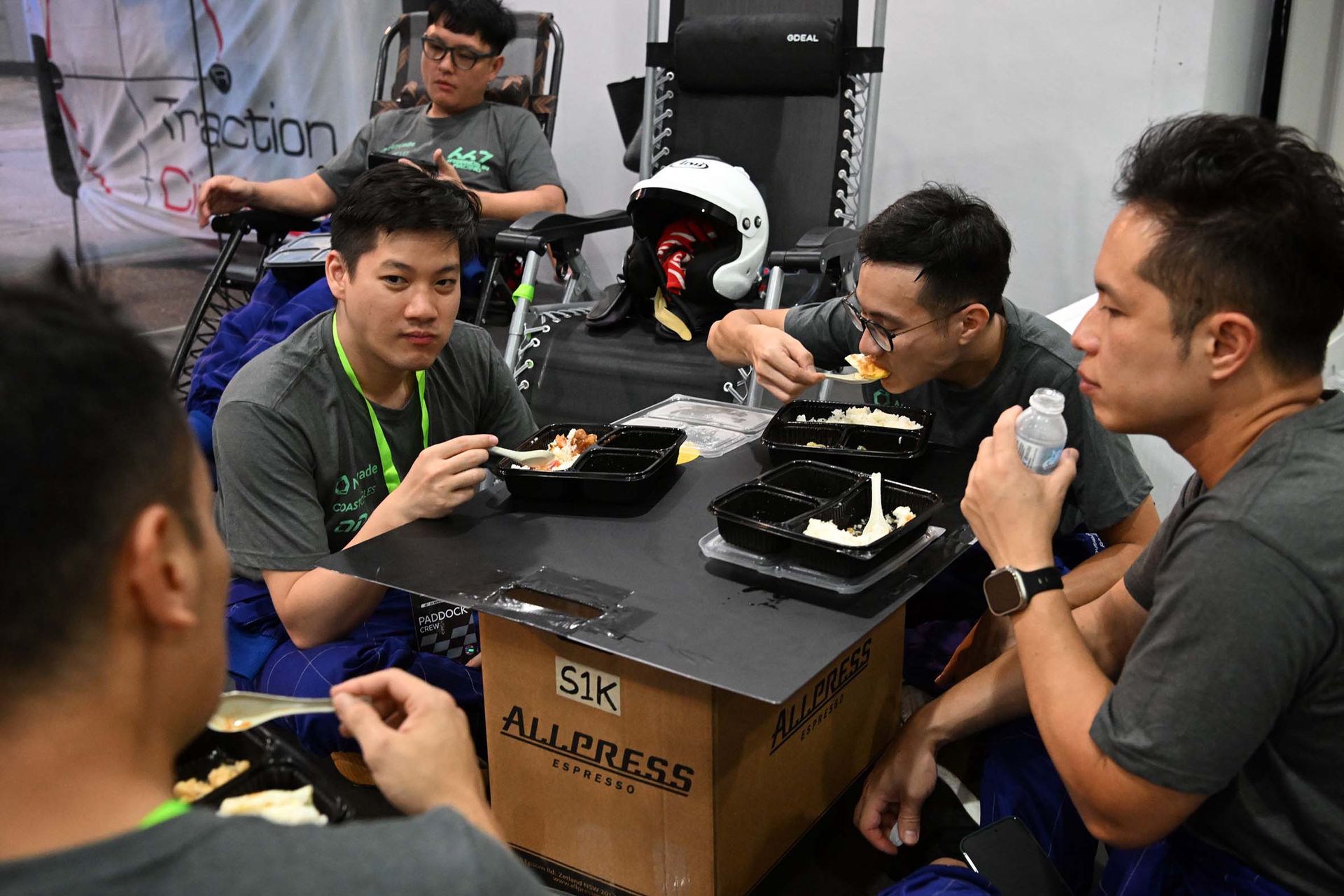 The pit crew from Team 667 having a quick meal during the Sepang 1000km Endurance Race.